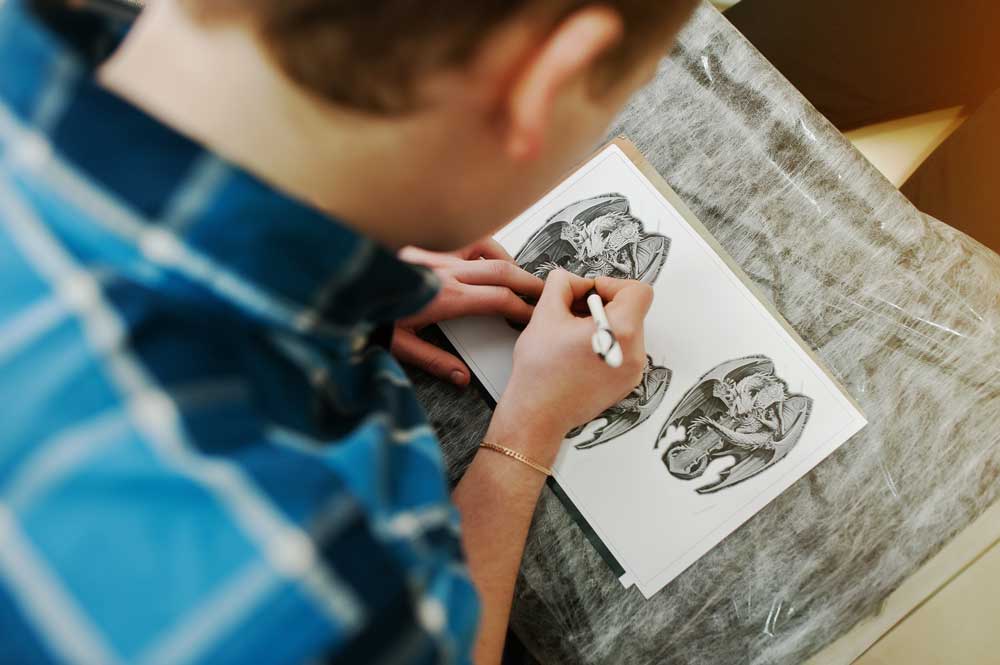 tattoo master preparing sketch for tattoo